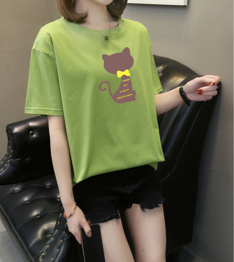 a woman wearing a green t - shirt with a monkey on it